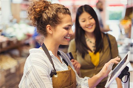 service with smile cashier - Female cashier helping customer at touch screen cash register in grocery store Stock Photo - Premium Royalty-Free, Code: 6113-09058586