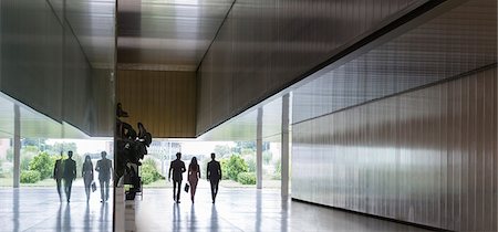 Silhouette business people walking in modern corridor Stock Photo - Premium Royalty-Free, Code: 6113-09058885