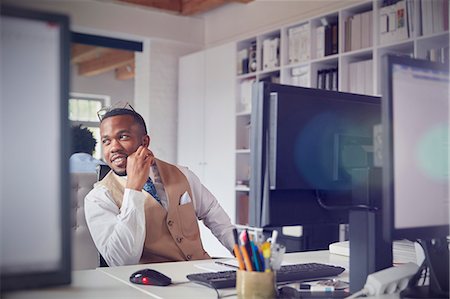 simsearch:6113-07565805,k - Smiling businessman working at computer in office Stock Photo - Premium Royalty-Free, Code: 6113-09058970