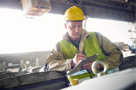 simsearch:6113-08393850,k - Steelworker writing on clipboard in steel mill Photographie de stock - Premium Libres de Droits, Code: 6113-09059043
