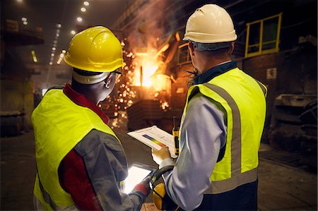 supervising - Steelworkers with digital tablet and clipboard talking in steel mill Stock Photo - Premium Royalty-Free, Code: 6113-09059060