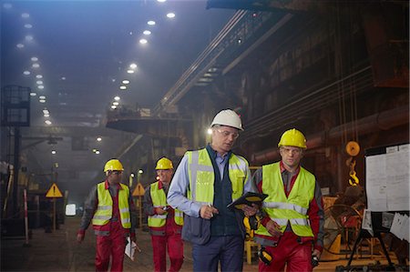 simsearch:6113-08655293,k - Supervisor and steelworkers walking and talking in steel mill Stock Photo - Premium Royalty-Free, Code: 6113-09059062