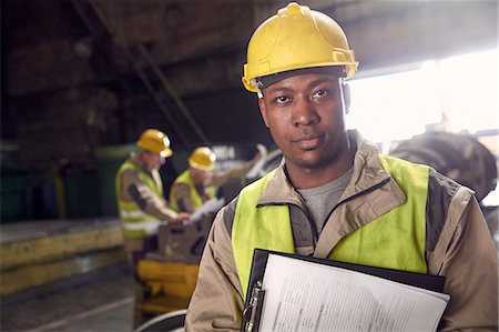 simsearch:6113-08805556,k - Portrait serious, confident steelworker with clipboard in steel mill Stock Photo - Premium Royalty-Free, Code: 6113-09059075