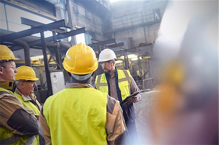 simsearch:6113-08655293,k - Supervisor and steelworkers talking in meeting in steel mill Stock Photo - Premium Royalty-Free, Code: 6113-09059036