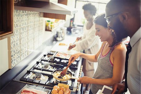 simsearch:649-07761247,k - Couple cooking scrambled eggs on stove in kitchen Stock Photo - Premium Royalty-Free, Code: 6113-09059380