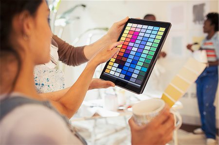 simsearch:6113-07762308,k - Young woman drinking coffee and viewing digital paint swatches on digital tablet Stock Photo - Premium Royalty-Free, Code: 6113-09059300