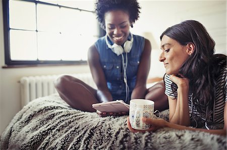 simsearch:6113-07147381,k - Women with headphones and coffee using digital tablet on bed Stock Photo - Premium Royalty-Free, Code: 6113-09059413