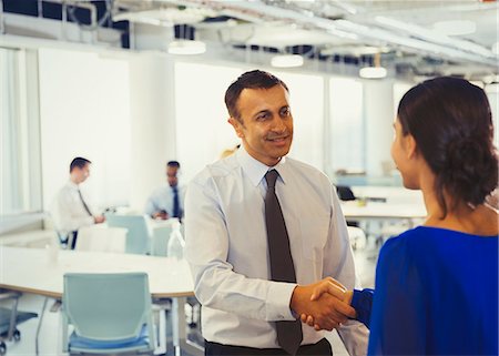 simsearch:6113-07242223,k - Businessman shaking hands with businesswoman in office Stock Photo - Premium Royalty-Free, Code: 6113-09005048