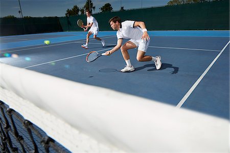 Young male tennis doubles players playing tennis on tennis court Stock Photo - Premium Royalty-Free, Code: 6113-09005064