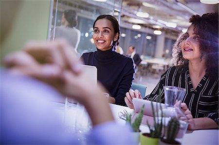 Smiling businesswomen listening in conference room meeting Stock Photo - Premium Royalty-Free, Code: 6113-09005027
