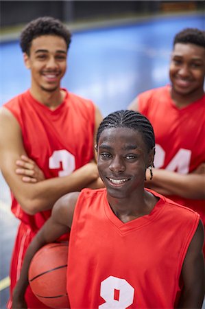 simsearch:6113-07730475,k - Portrait smiling, confident young male basketball player team in red jerseys Stock Photo - Premium Royalty-Free, Code: 6113-09005143