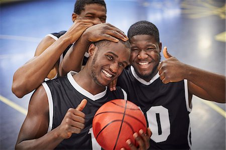 simsearch:6113-07730475,k - Portrait smiling, confident young male basketball player team celebrating, gesturing thumbs-up Stock Photo - Premium Royalty-Free, Code: 6113-09005163