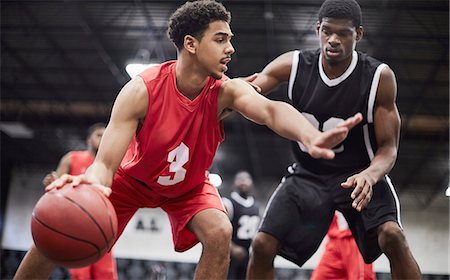simsearch:6113-08698170,k - Young male basketball player dribbling the ball, protecting from defender in basketball game Stock Photo - Premium Royalty-Free, Code: 6113-09005124