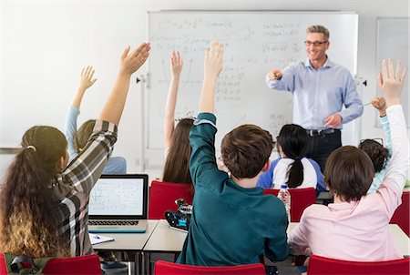 simsearch:614-06895765,k - Male teacher calling on students in classroom Stock Photo - Premium Royalty-Free, Code: 6113-09027261