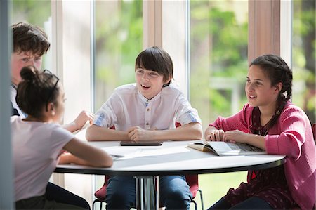 simsearch:614-06895765,k - Students talking at table in library Stock Photo - Premium Royalty-Free, Code: 6113-09027278