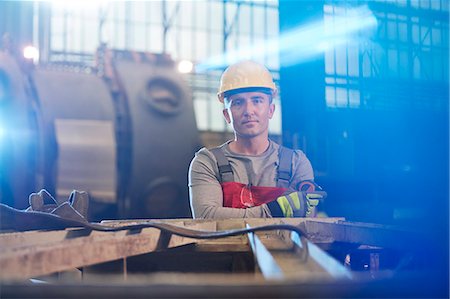 portrait 30s man not woman - Portrait tough male worker working in factory Stock Photo - Premium Royalty-Free, Code: 6113-09027472