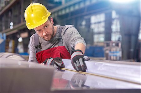 simsearch:649-07238739,k - Focused male worker examining steel in factory Stock Photo - Premium Royalty-Free, Code: 6113-09027494