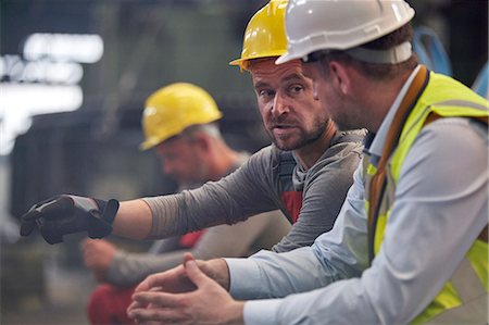 Male workers talking in factory Stock Photo - Premium Royalty-Free, Code: 6113-09027543