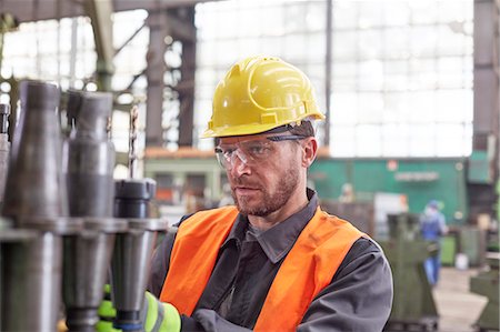 simsearch:649-07238739,k - Focused male worker examining steel parts in factory Stock Photo - Premium Royalty-Free, Code: 6113-09027534