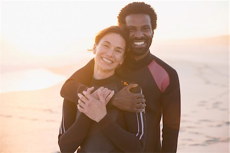 simsearch:6113-07565751,k - Portrait smiling, affectionate couple hugging on sunset summer beach Stock Photo - Premium Royalty-Free, Code: 6113-09027630
