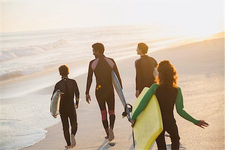 simsearch:6113-07147024,k - Family walking, carrying surfboards and boogie board on sunny summer sunset beach Stock Photo - Premium Royalty-Free, Code: 6113-09027740