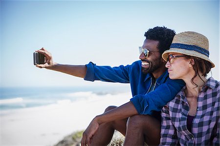 simsearch:632-05845211,k - Multi-ethnic couple taking selfie on sunny summer beach Stock Photo - Premium Royalty-Free, Code: 6113-09027741