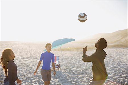 simsearch:649-08004031,k - Father and children playing soccer on sunny summer beach Stock Photo - Premium Royalty-Free, Code: 6113-09027775