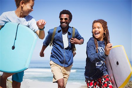 simsearch:6113-06899255,k - Happy father and children with boogie boards running on sunny summer beach Stock Photo - Premium Royalty-Free, Code: 6113-09027723