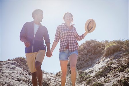 simsearch:632-05845211,k - Multi-ethnic couple walking, holding hands on sunny summer beach path Stock Photo - Premium Royalty-Free, Code: 6113-09027725