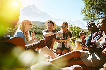 simsearch:614-06719795,k - Young friends hanging out, enjoying picnic in sunny summer park Stock Photo - Premium Royalty-Free, Code: 6113-09027859