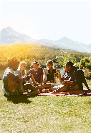 simsearch:614-06719795,k - Young friends hanging out, playing guitar and enjoying picnic in sunny summer grass Stock Photo - Premium Royalty-Free, Code: 6113-09027865
