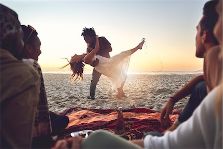 simsearch:6113-07147024,k - Playful young couple dancing on sunny summer beach Stock Photo - Premium Royalty-Free, Code: 6113-09027871