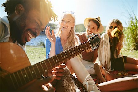 simsearch:614-06719795,k - Young friends laughing and playing guitar, enjoying sunny summer picnic Stock Photo - Premium Royalty-Free, Code: 6113-09027880