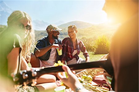 simsearch:614-06719795,k - Young friends enjoying picnic in sunny summer park Stock Photo - Premium Royalty-Free, Code: 6113-09027890