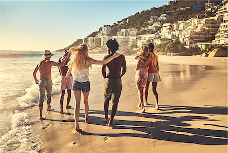 simsearch:6113-07147024,k - Young couple friends walking on sunny summer beach Stock Photo - Premium Royalty-Free, Code: 6113-09027838