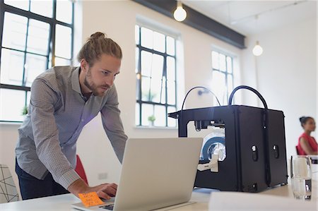 simsearch:649-06845199,k - Male designer working at laptop next to 3D printer in office Stock Photo - Premium Royalty-Free, Code: 6113-09144475