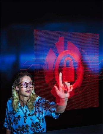 simsearch:614-06442506,k - Businesswoman accessing security feature on futuristic hologram computer Photographie de stock - Premium Libres de Droits, Code: 6113-09144482