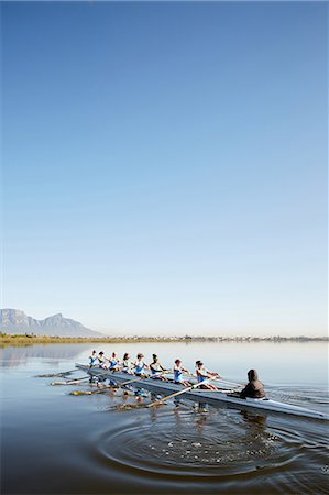 simsearch:700-01633002,k - Female rowers rowing scull on tranquil lake under blue sky Stock Photo - Premium Royalty-Free, Code: 6113-09144560