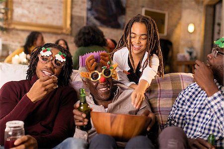 simsearch:693-06435898,k - Playful multi-generation family wearing Christmas glasses, enjoying popcorn Stock Photo - Premium Royalty-Free, Code: 6113-09144593