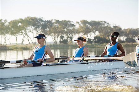 simsearch:700-01633002,k - Female rowing team rowing scull on sunny lake Stock Photo - Premium Royalty-Free, Code: 6113-09144513