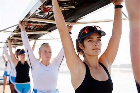 simsearch:6113-06499152,k - Confident, determined female rowing team lifting scull overhead Stock Photo - Premium Royalty-Free, Code: 6113-09144518