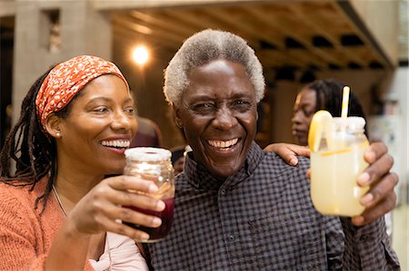 Happy senior father and daughter drinking lemonade and sangria Stock Photo - Premium Royalty-Free, Code: 6113-09144662