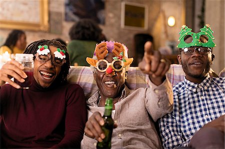 simsearch:6113-07148073,k - Portrait playful grandfather and grandsons wearing Christmas costume goggles Stock Photo - Premium Royalty-Free, Code: 6113-09144672