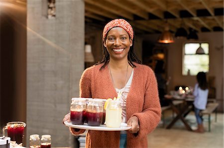 Portrait smiling, confident woman serving lemonade and sangria Stock Photo - Premium Royalty-Free, Code: 6113-09144683