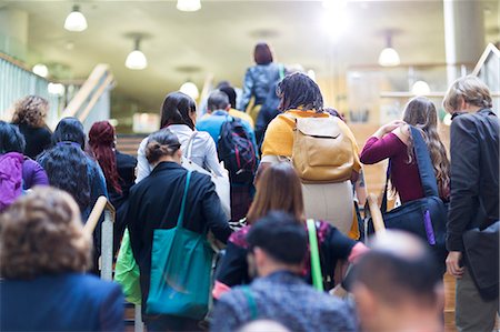 Crowd of people with backpacks and bags climbing stairs Stock Photo - Premium Royalty-Free, Code: 6113-09157376