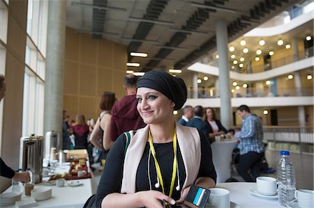 simsearch:6113-07565805,k - Smiling, confident businesswoman in headscarf at conference Stock Photo - Premium Royalty-Free, Code: 6113-09157417