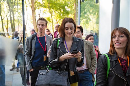 simsearch:6113-06899131,k - Businesswoman with smart phone arriving, entering doorway Stock Photo - Premium Royalty-Free, Code: 6113-09157542