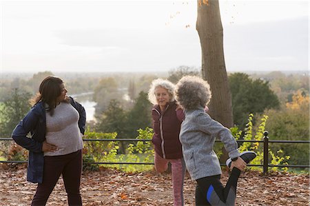 Active senior women friends stretching legs, preparing for run in autumn park Stock Photo - Premium Royalty-Free, Code: 6113-09157581