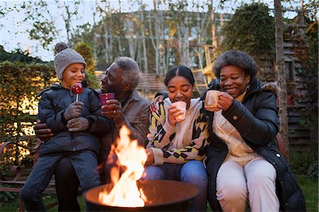 simsearch:6113-07565586,k - Grandparents and grandchildren drinking hot cocoa at campfire Stock Photo - Premium Royalty-Free, Code: 6113-09157655