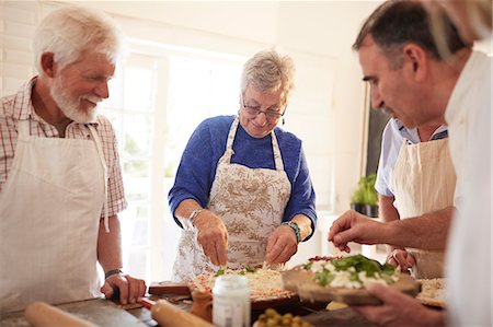 simsearch:649-07761247,k - Active senior friends making pizza in cooking class Stock Photo - Premium Royalty-Free, Code: 6113-09157688